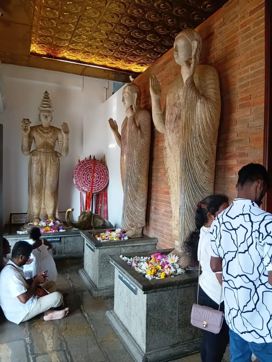 Ancient standing Buddha statues inside a cave temple
