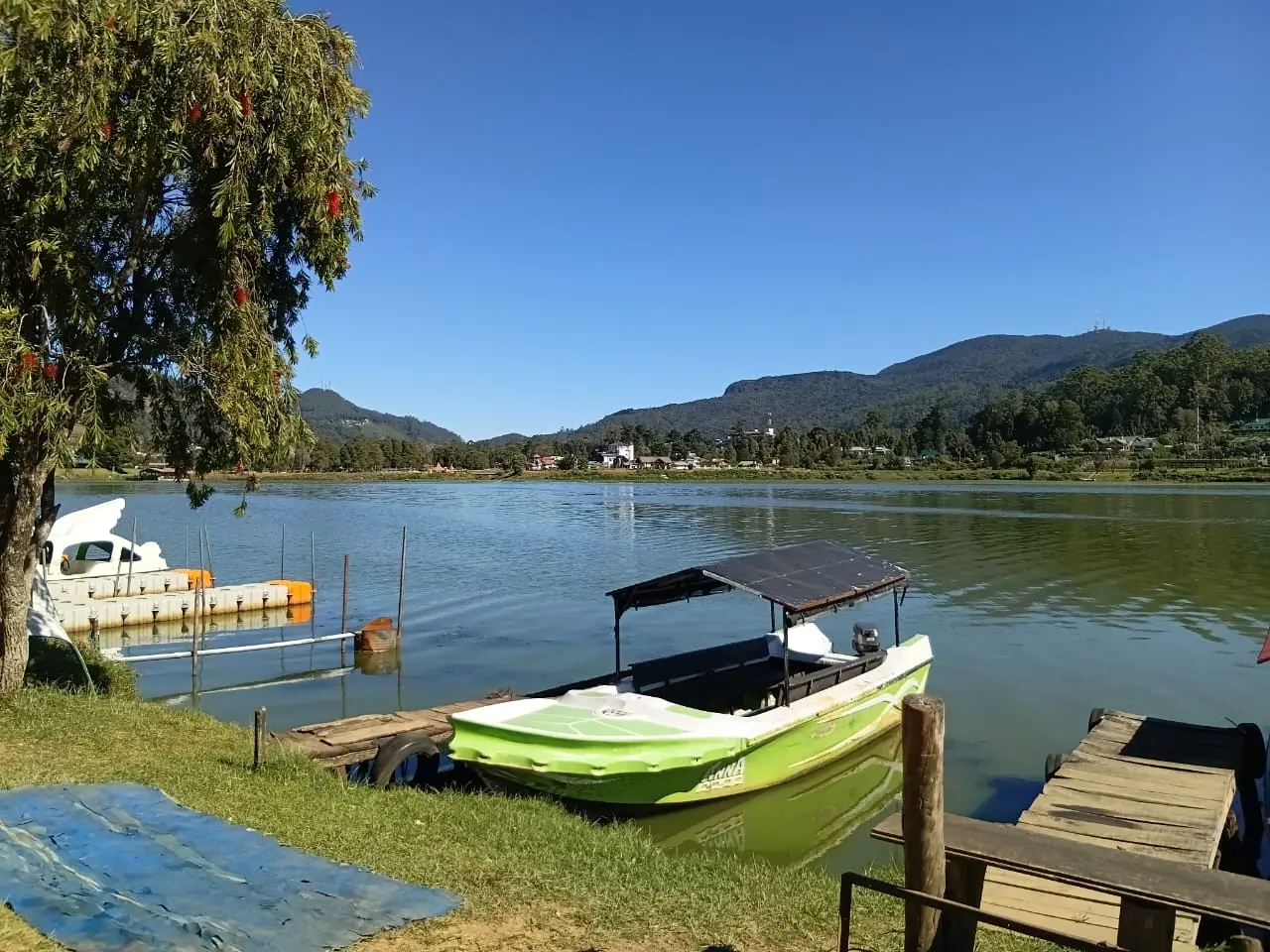 A boat moored on a still lake beneath the hills