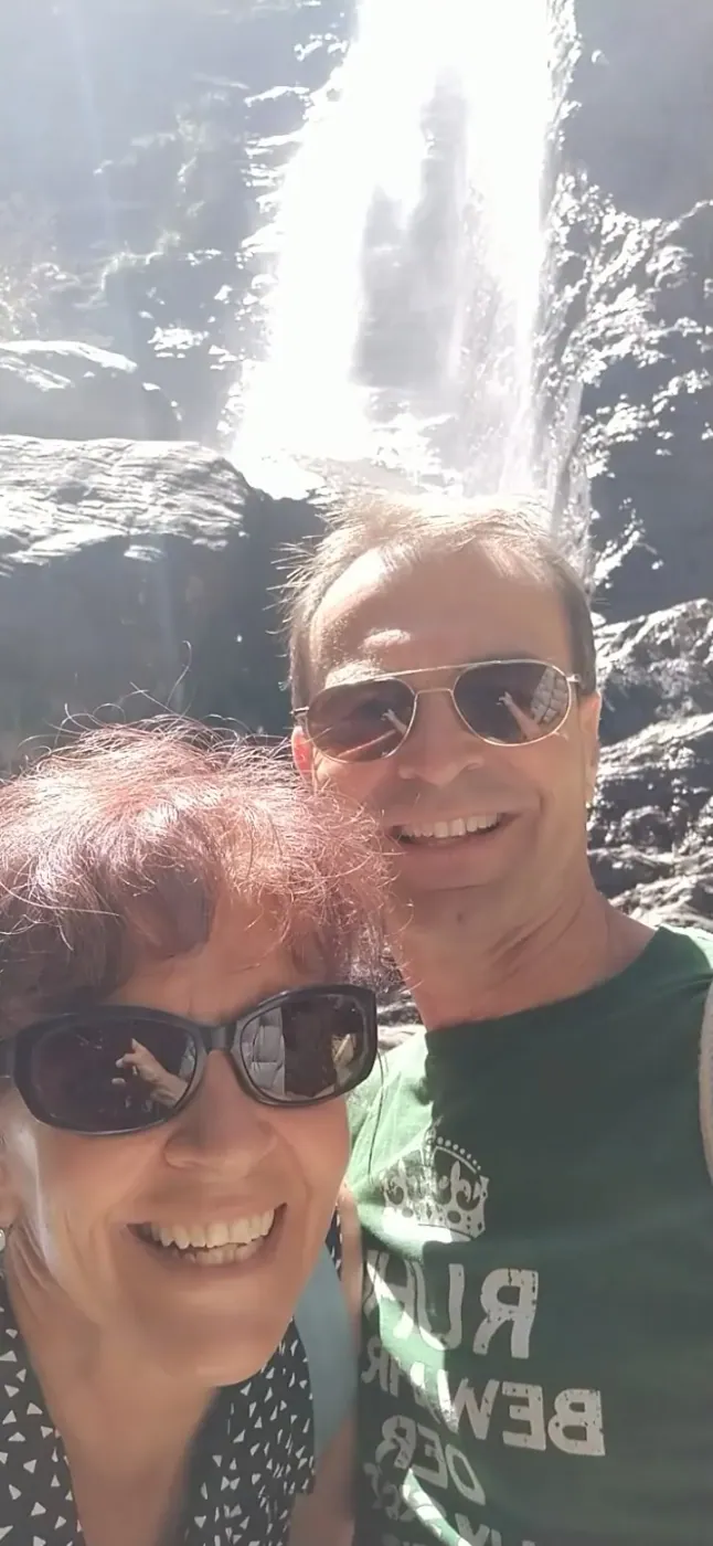 A couple at a hill country waterfall