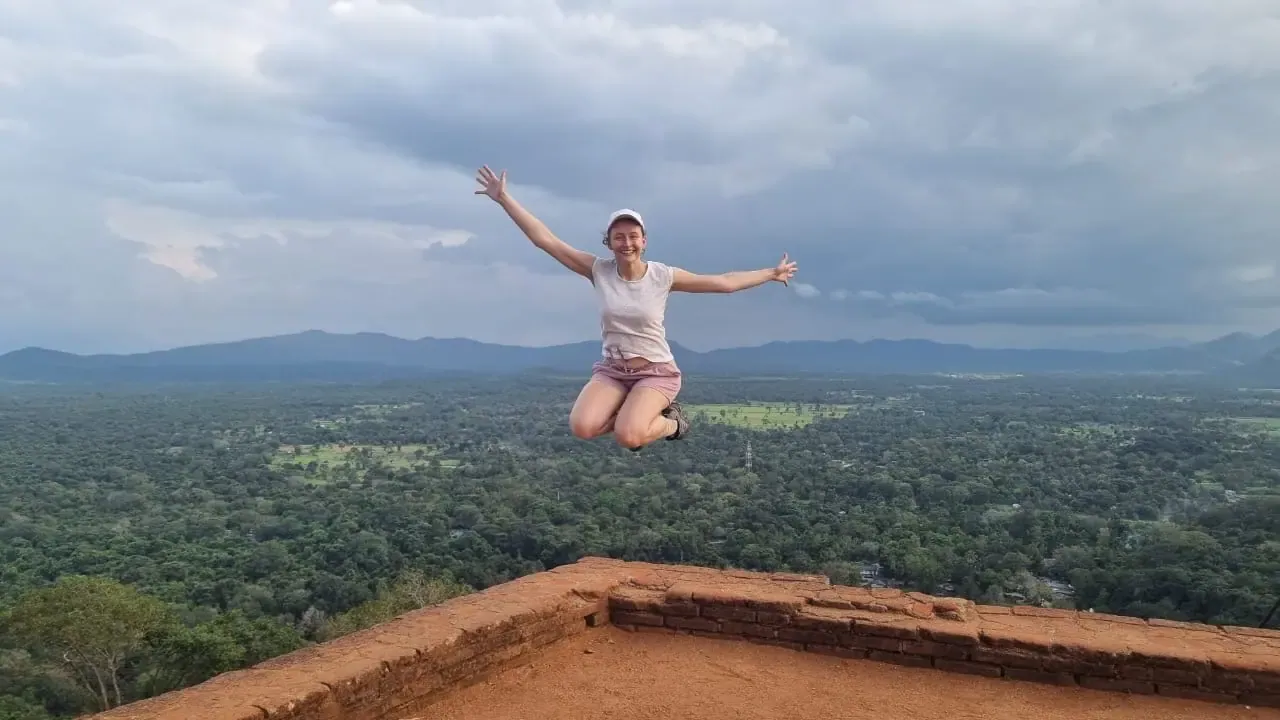 A guest celebrating on Sigiriya with the jungle stretching below