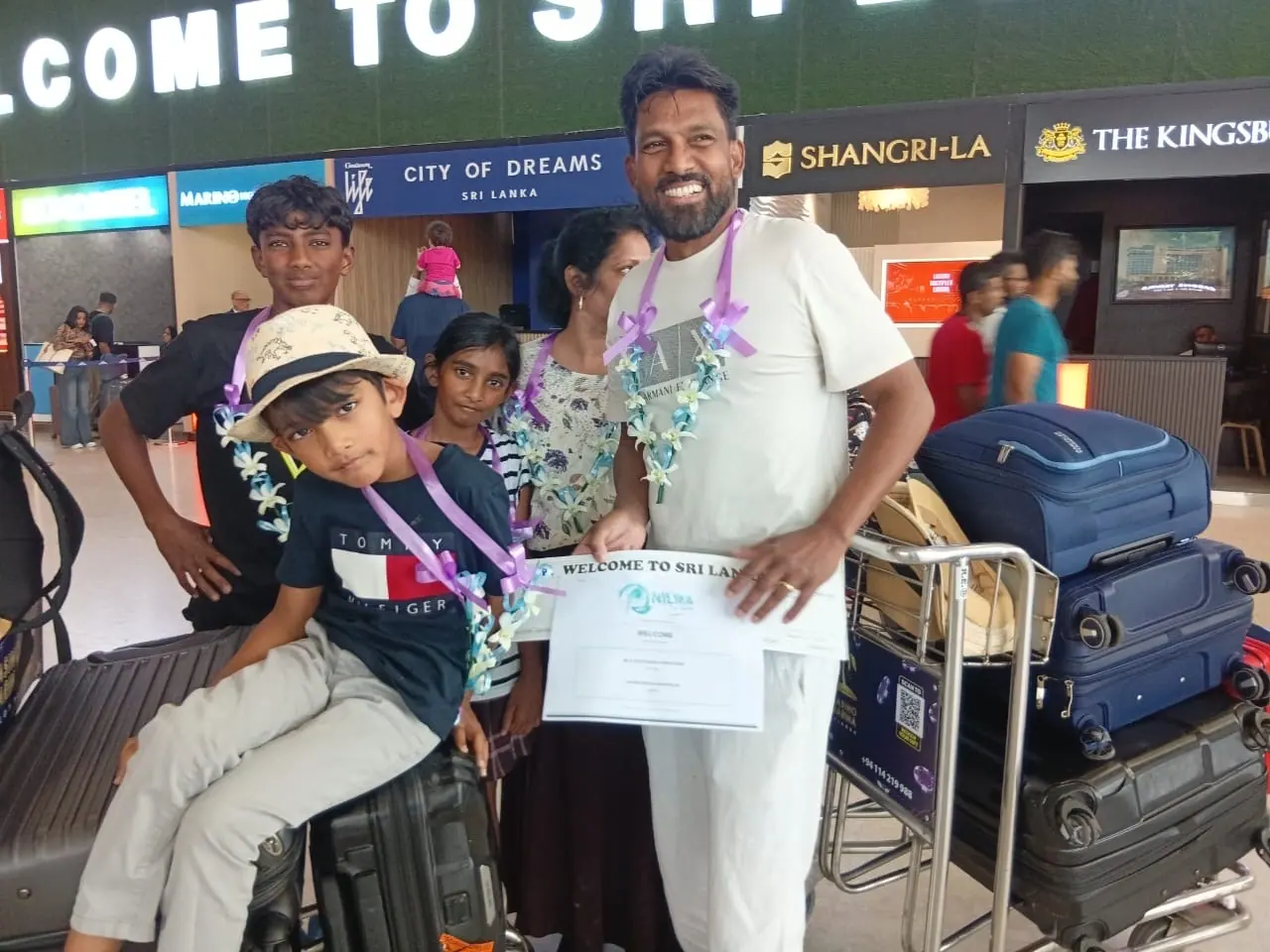 Kings Holidays team handing a welcome pack to arriving guests