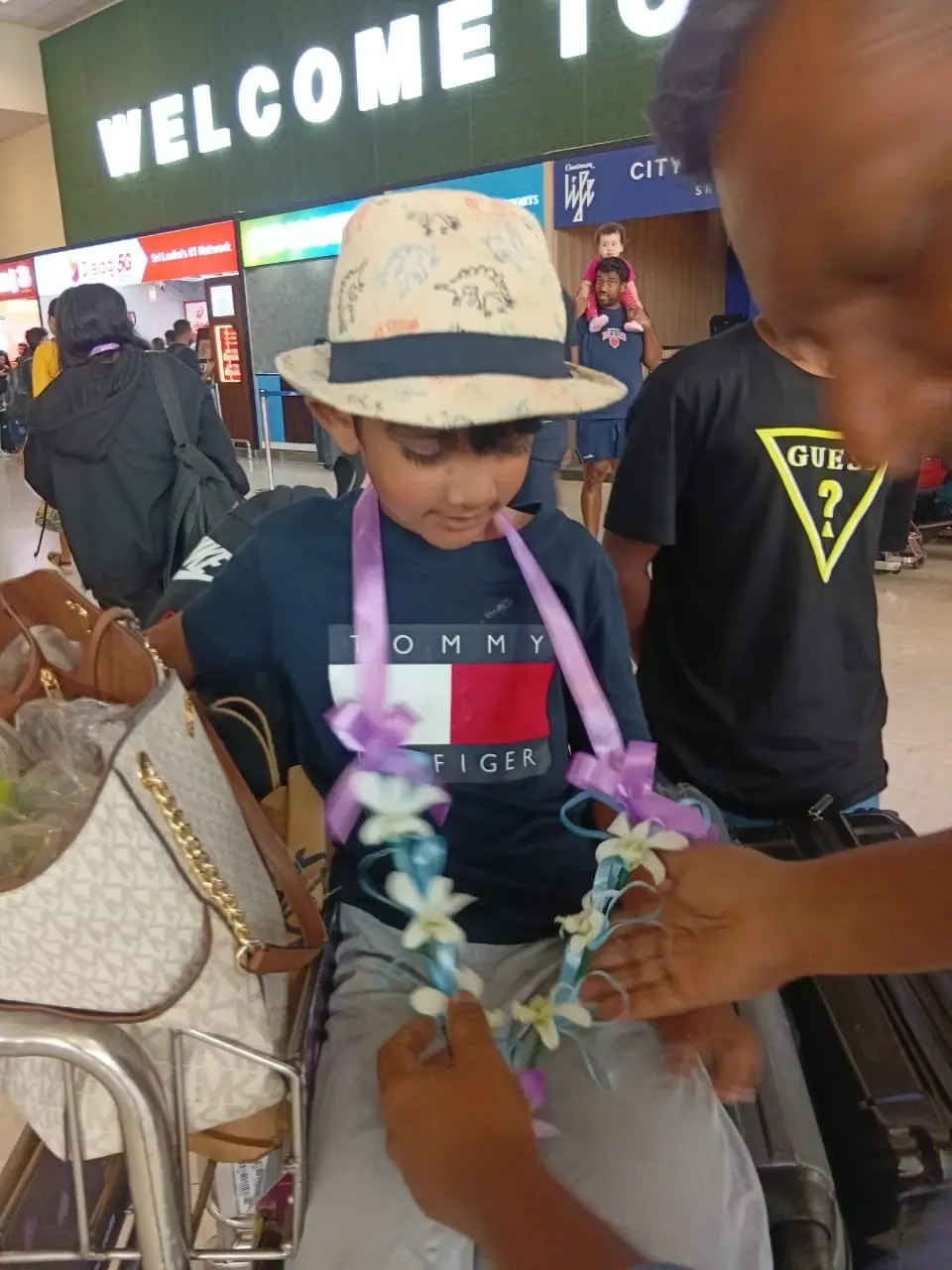 A guest receiving a traditional flower garland on arrival