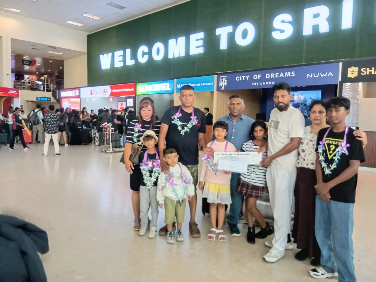 Guests met under the Welcome to Sri Lanka sign at Colombo arrivals