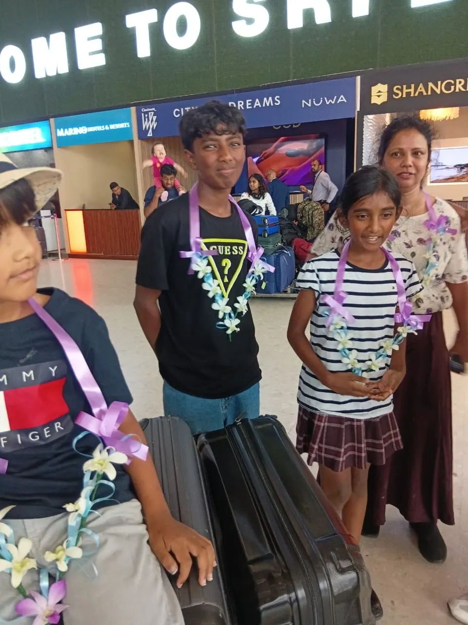 A young family garlanded at Colombo airport arrivals